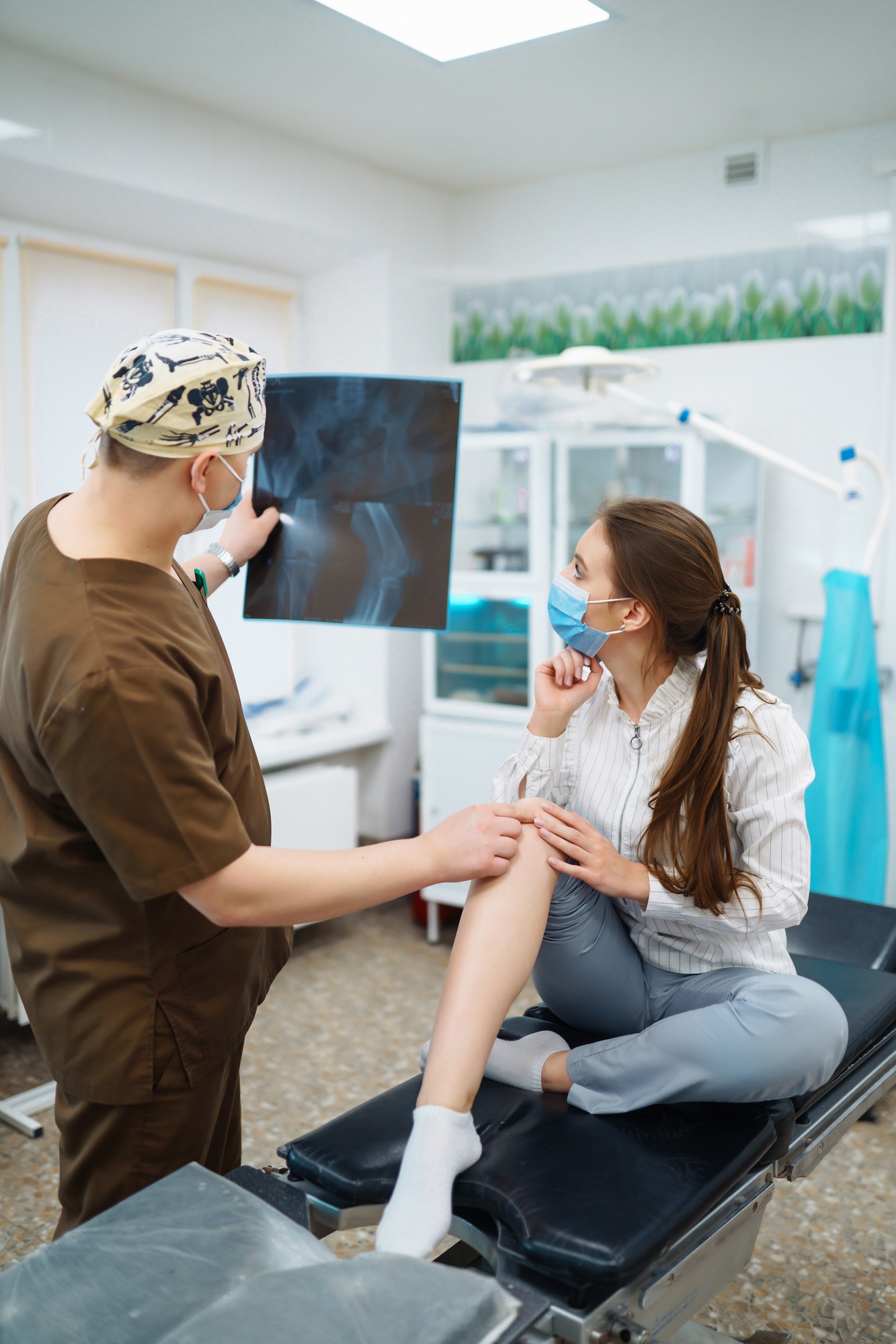 Doctor examines x-ray of patient leg. Foot and sprain concept. Sport exercise injuries.